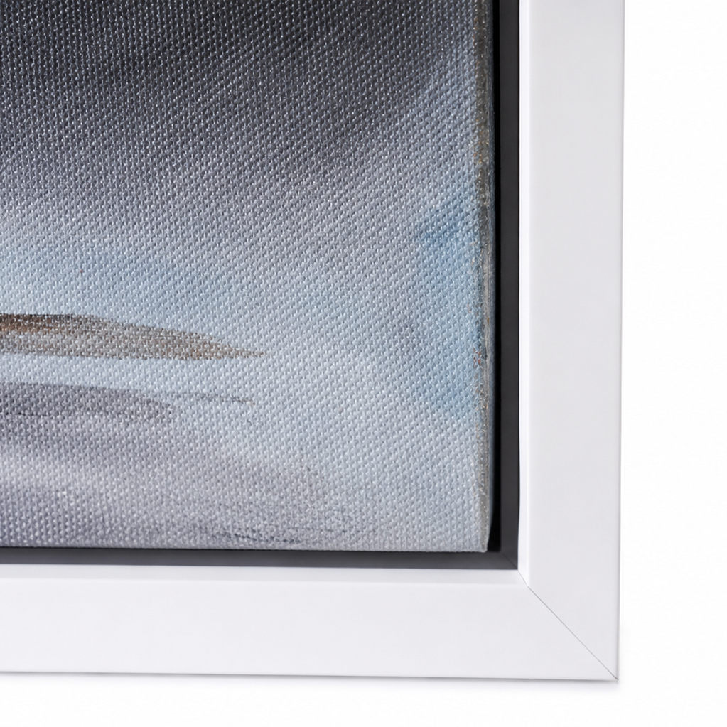 Close-up of a framed wall art piece showing part of a textured abstract landscape in soft blue, gray, and white tones with a white frame.