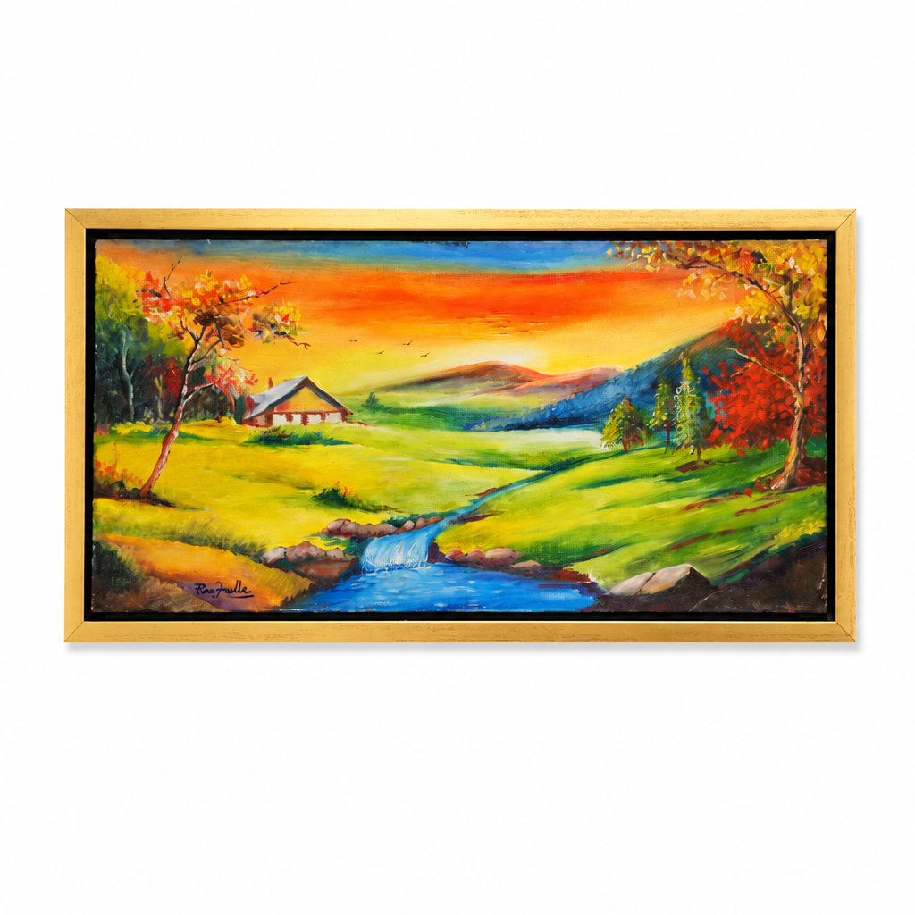 A framed landscape painting featuring a vibrant autumn valley with a blue stream, green fields, a small cabin, and colorful trees under a bright orange and yellow sky, set in a light wood frame against a white background.